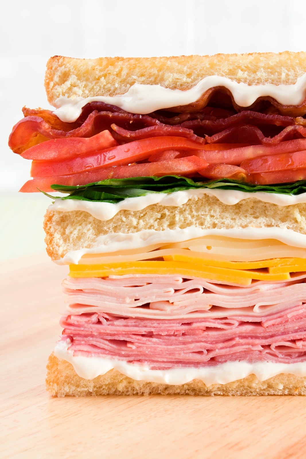 Stacked Italian sub sandwich with fresh mozzarella, tomatoes and basil